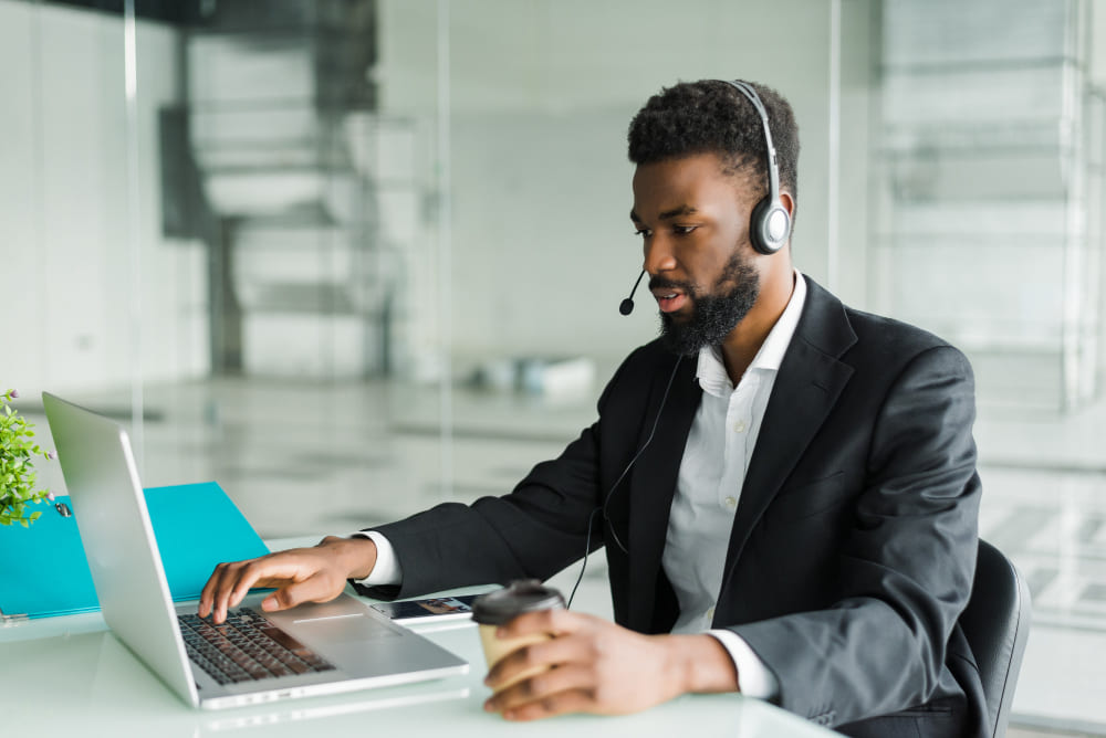 african-american-man-customer-support-operator-with-hands-free-headset-working-office-2